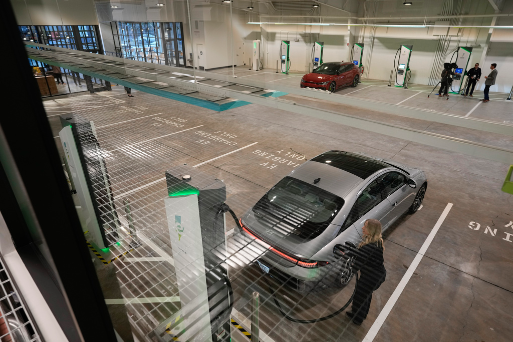 A car gets charged at the new Electrify America indoor electric vehicle charging station during a preview in San Francisco, Wednesday, Feb. 7, 2024.