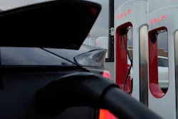 A vehicle charges at a Tesla Supercharger station in Detroit, Nov. 16, 2022.