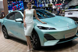 A model stands next to CHANGAN's electric vehicle 'Deepal LO7' during the 45th Bangkok Motor Show in Nonthaburi, Thailand, Tuesday, March 26, 2024.