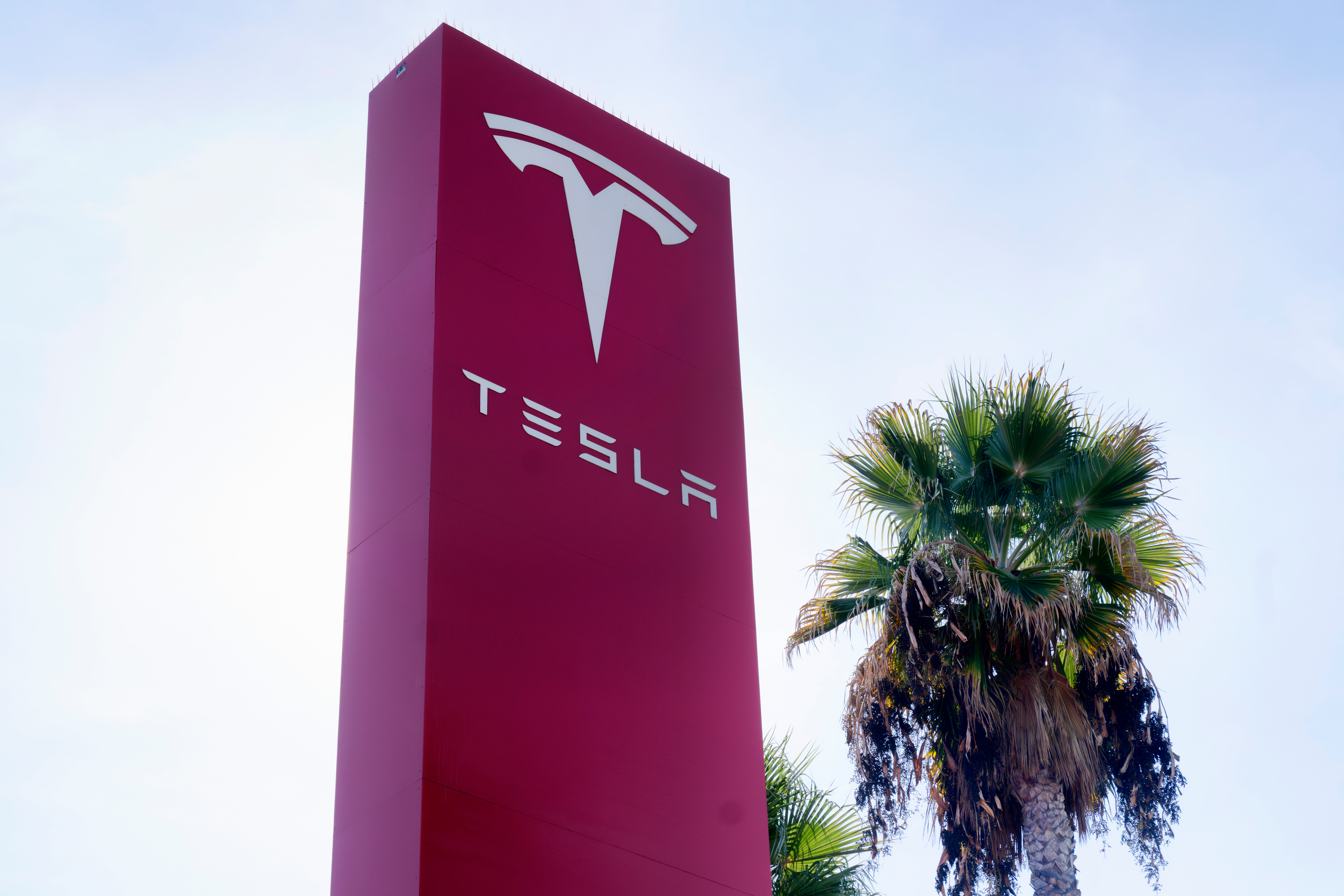 A Tesla sign is seen at a dealership, Dec. 3, 2023, in Buena Park, Calif.