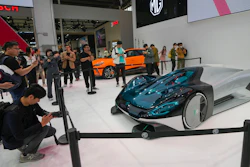 Visitors take photos of a MG concept car during an opening of China Auto Show in Beijing, China, Thursday, April 25, 2024.