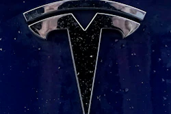 A Tesla electric vehicle emblem is affixed to a passenger vehicle Sunday, Feb. 21, 2021, in Boston.