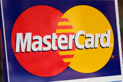 A sign indicating MasterCard credit cards are accepted is posted at a New York business, Jan. 21, 2015.