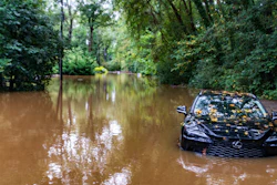 A partially submerged vehicle sits in flood water from after Hurricane Helene passed the area, Friday, Sept 27, 2024, in Atlanta.