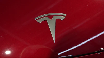 The logo of Tesla car is pictured at the Paris Auto Show, in Paris, Monday, Oct. 14, 2024.