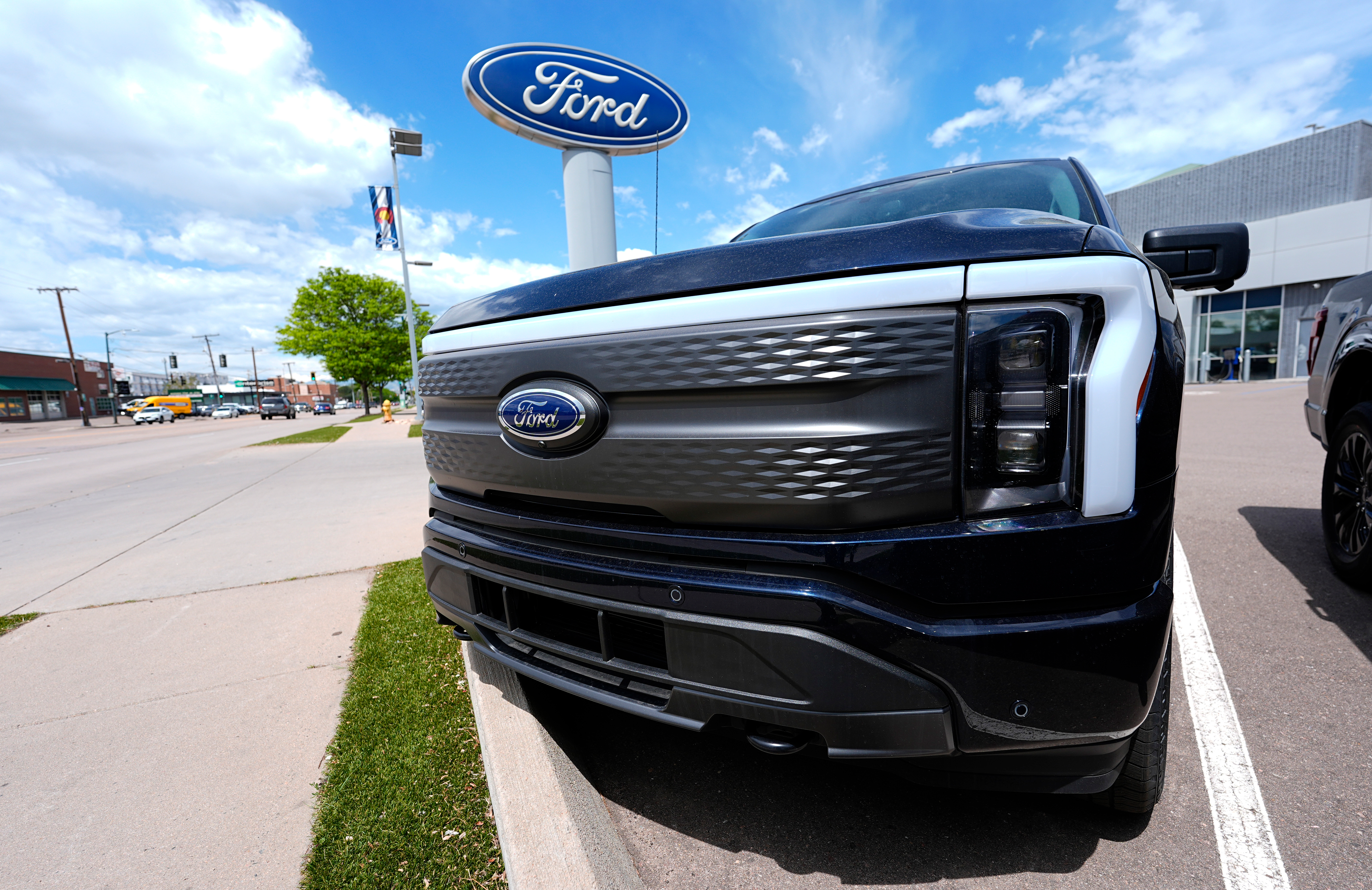 An unsold 2024 Lightning electric pickup truck sits at a Ford dealership May 19, 2024, in Denver.