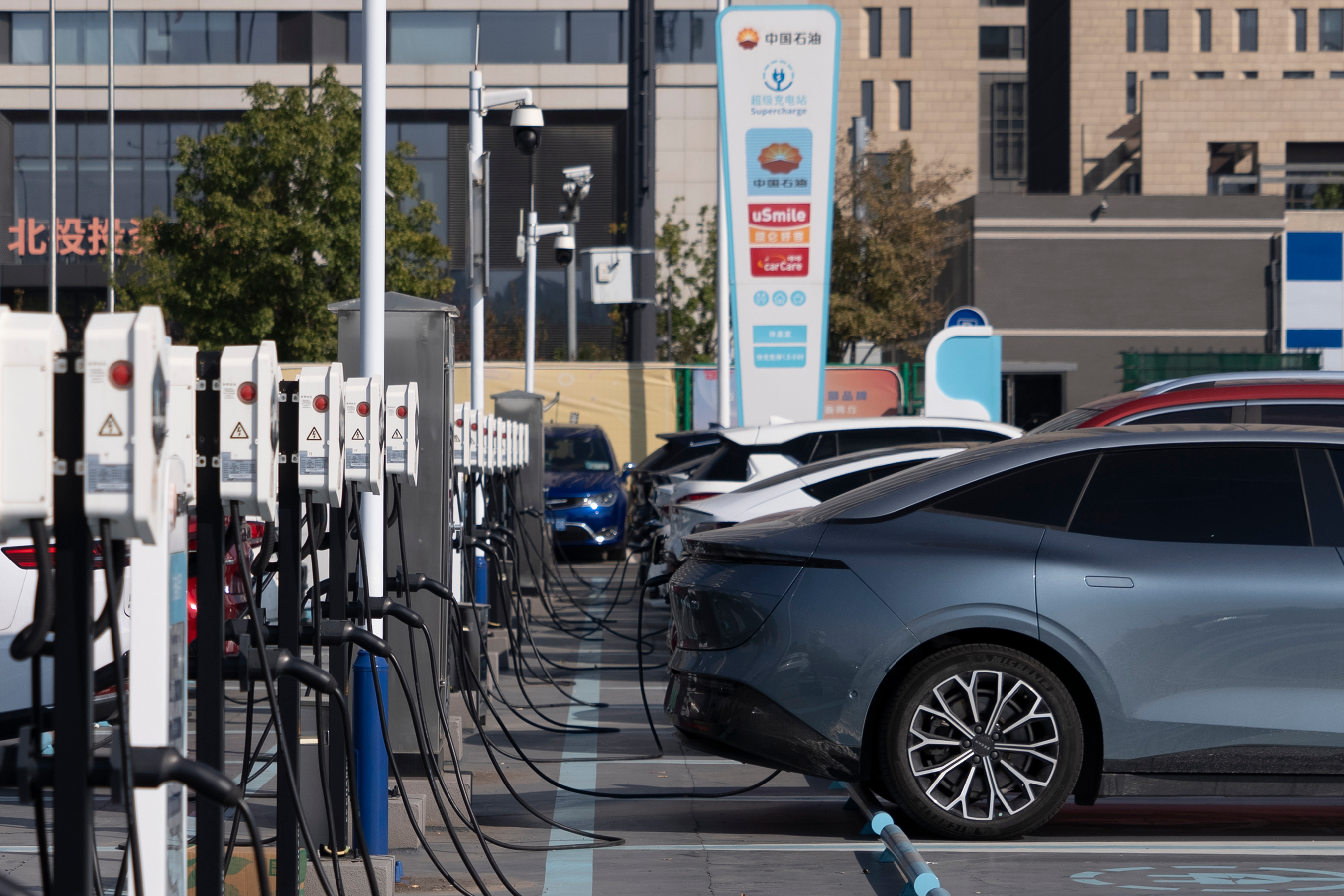 Electric vehicle charging stations are seen in Beijing, Friday, Oct. 11, 2024.
