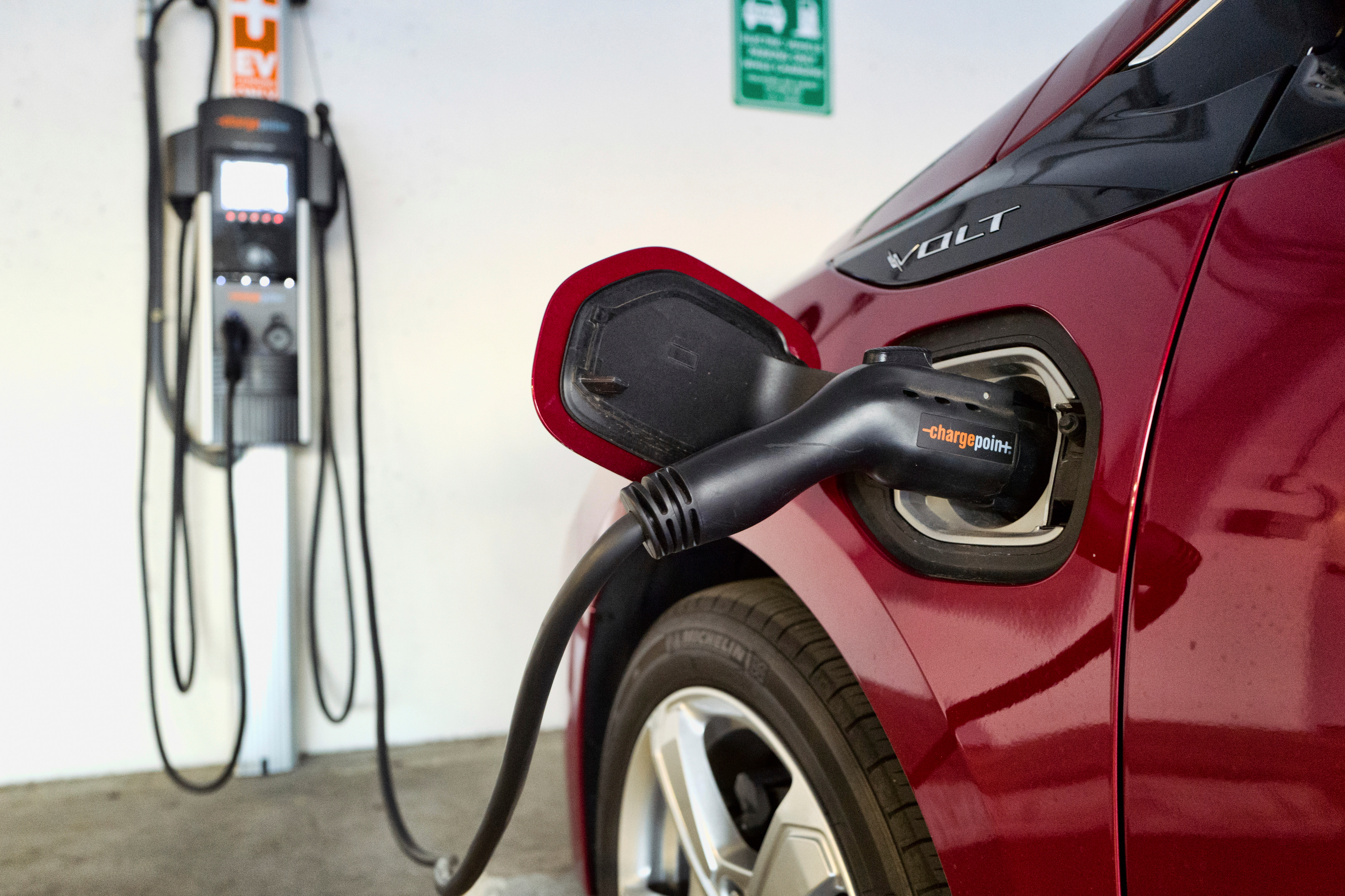 An electric vehicle is charged at a parking garage in Los Angeles, Oct. 17, 2018.
