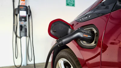 An electric vehicle is charged at a parking garage in Los Angeles, Oct. 17, 2018.