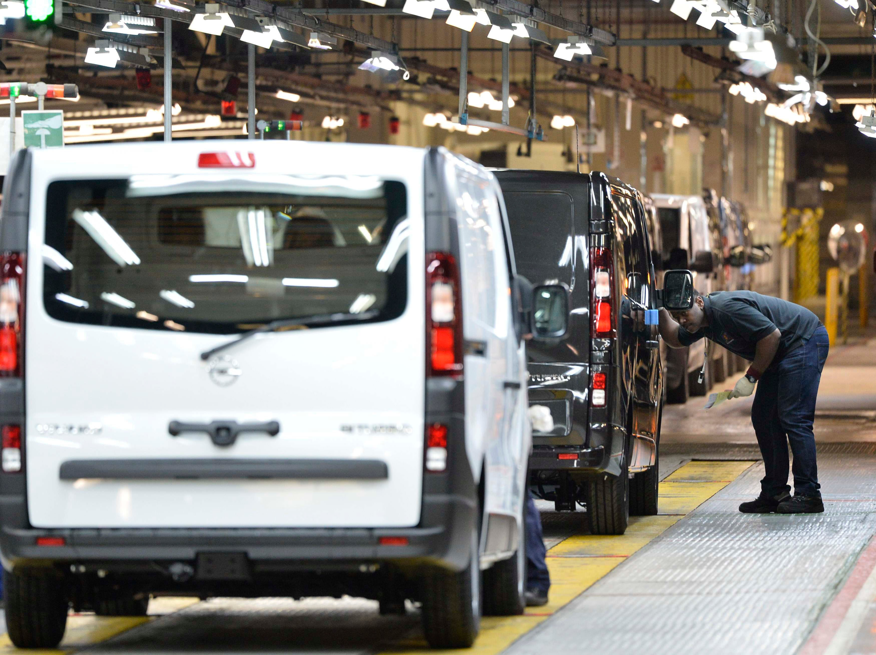 An employee inspects a car at the Vauxhall vehicle production plant in Luton, England, Feb. 2, 2015.