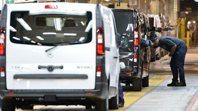 An employee inspects a car at the Vauxhall vehicle production plant in Luton, England, Feb. 2, 2015.