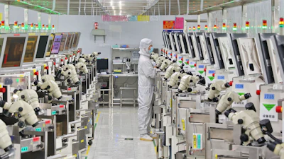 A man works at a manufacturer of Integrated Chip encapsulation in Nantong in eastern China's Jiangsu province on Friday, Sept. 16, 2022.