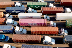 Trucks line up to enter a Port of Oakland shipping terminal in Oakland, Calif., Nov. 10, 2021.