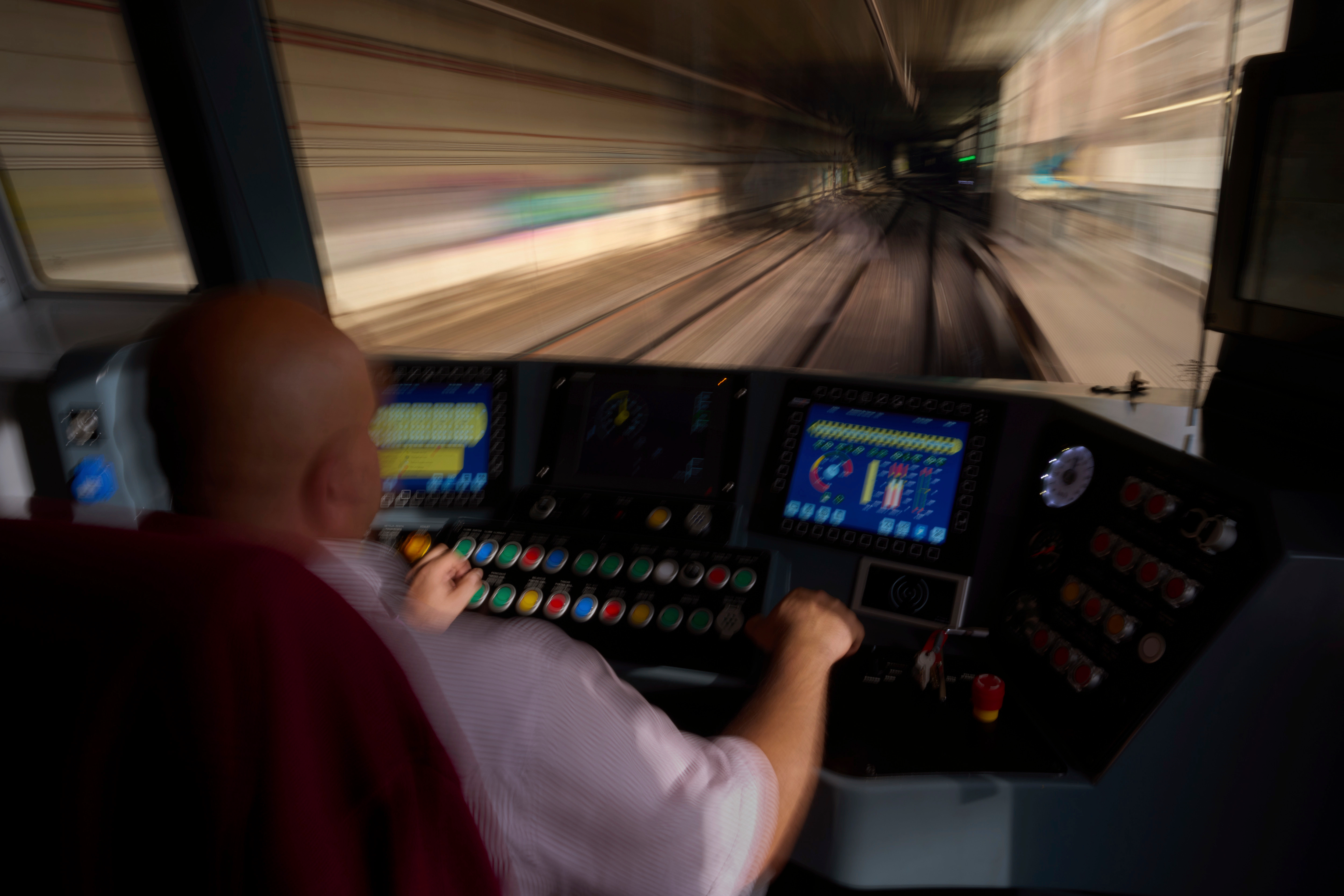 A subway driver operates the train's brake lever before entering a station in Barcelona, Spain, Monday, Dec. 2, 2024.