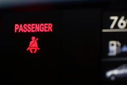 A seat belt warning sign for the right front passenger seat is displayed in a vehicle on Monday, Aug. 21, 2023.