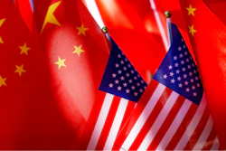 American flags are displayed with Chinese flags on top of a trishaw on Sept. 16, 2018, in Beijing.