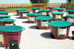 Outdoor experimental setup of artificial ponds (mesocosms) used for studying how aquatic microbes are affected by the effects of connectivity loss within habitat networks.