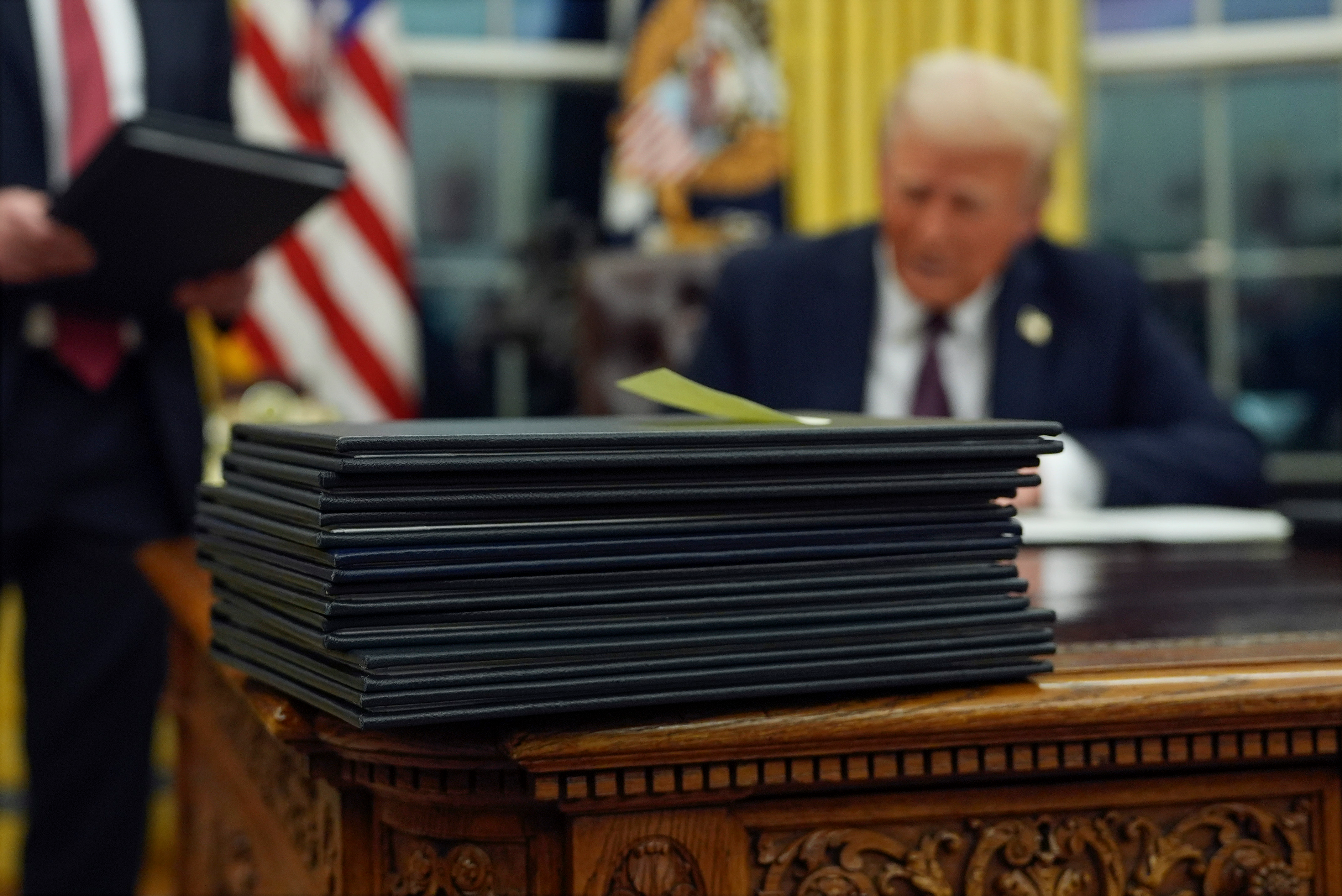 President Donald Trump signs executive orders in the Oval Office of the White House, Jan. 20, 2025, in Washington.