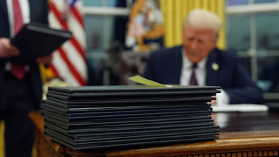 President Donald Trump signs executive orders in the Oval Office of the White House, Jan. 20, 2025, in Washington.