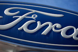 The Ford company logo is seen, Oct. 24, 2021, on a sign at a Ford dealership in southeast Denver.