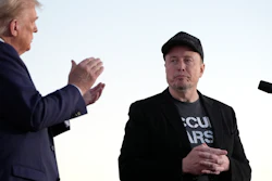 Republican presidential nominee former President Donald Trump, left, claps as Tesla and SpaceX CEO Elon Musk prepares to depart after speaking at a campaign event at the Butler Farm Show, on Oct. 5, 2024, in Butler, Pa.