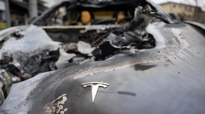 A burnt-out Tesla car stands in the Steglitz district of Berlin, Friday, March 14, 2025, as four Teslas are suspected to have been set on fire in Berlin last night.