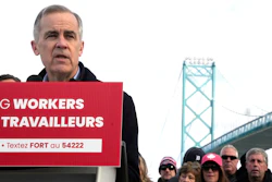 Unifor auto workers stand behind Liberal Leader Mark Carney as he speaks during a campaign stop at the Ambassador Bridge in Windsor, Ont., on Wednesday, March 26, 2025.