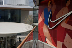 A man walks past Apple and Nike stores in Beijing, China, Friday, April 4, 2025.