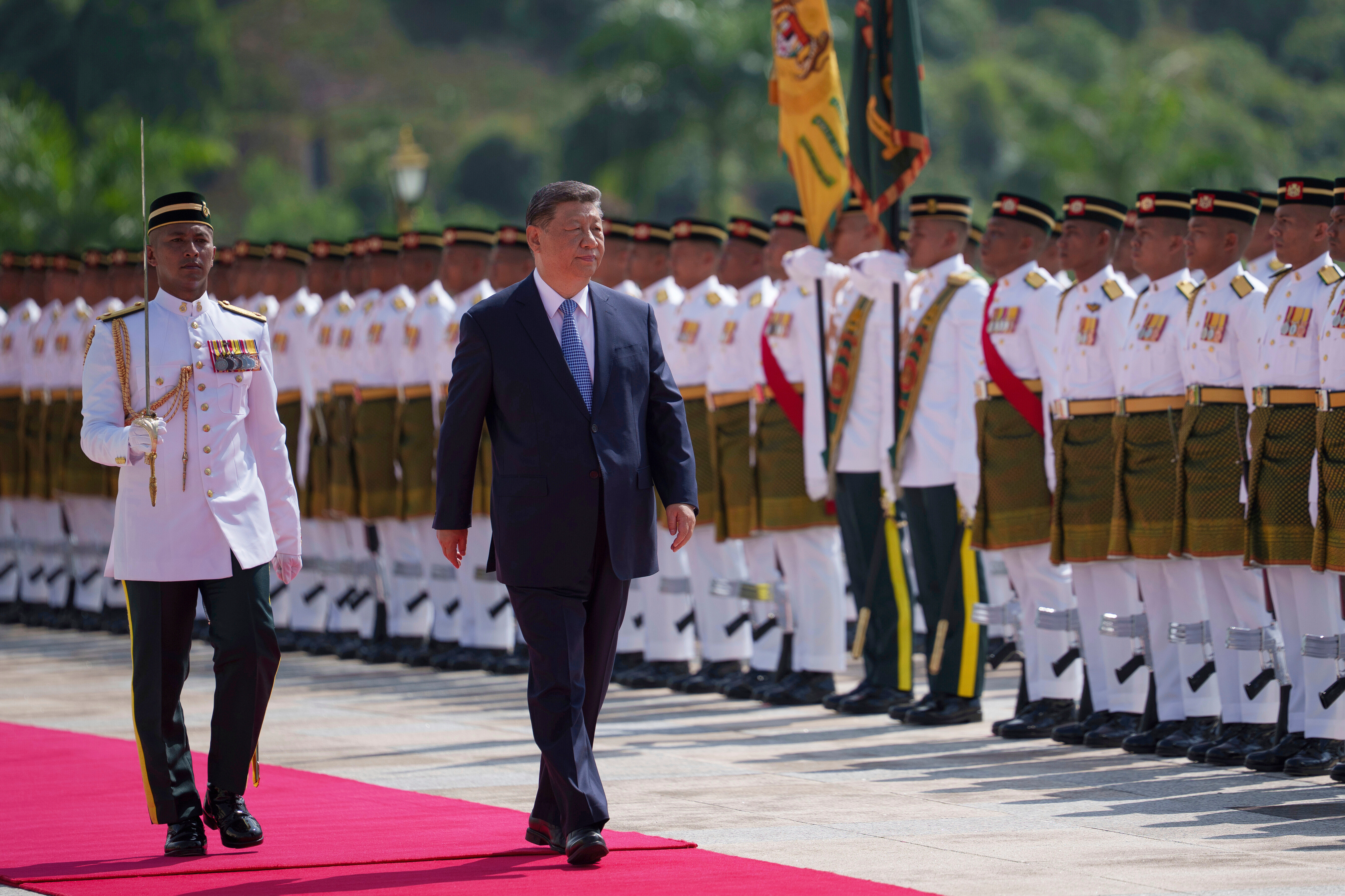 Chinese President Xi Jinping inspects honor guards during the official welcoming ceremony at the national palace in Kuala Lumpur, Malaysia, Wednesday, April 16, 2025.