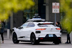 A Waymo self-driving vehicle sits curbside on Dec. 16, 2022, at the Sky Harbor International Airport Sky Train facility in Phoenix.