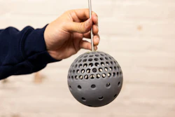Mechanical Engineering Masters Student, Putu Brahmanda Sudarsana, holds a 3D printed sphere with holes at the Marine Hydrodynamics laboratory on University of Michigan's Central Campus in Ann Arbor, MI on December 17, 2024.