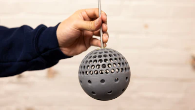 Mechanical Engineering Masters Student, Putu Brahmanda Sudarsana, holds a 3D printed sphere with holes at the Marine Hydrodynamics laboratory on University of Michigan's Central Campus in Ann Arbor, MI on December 17, 2024.