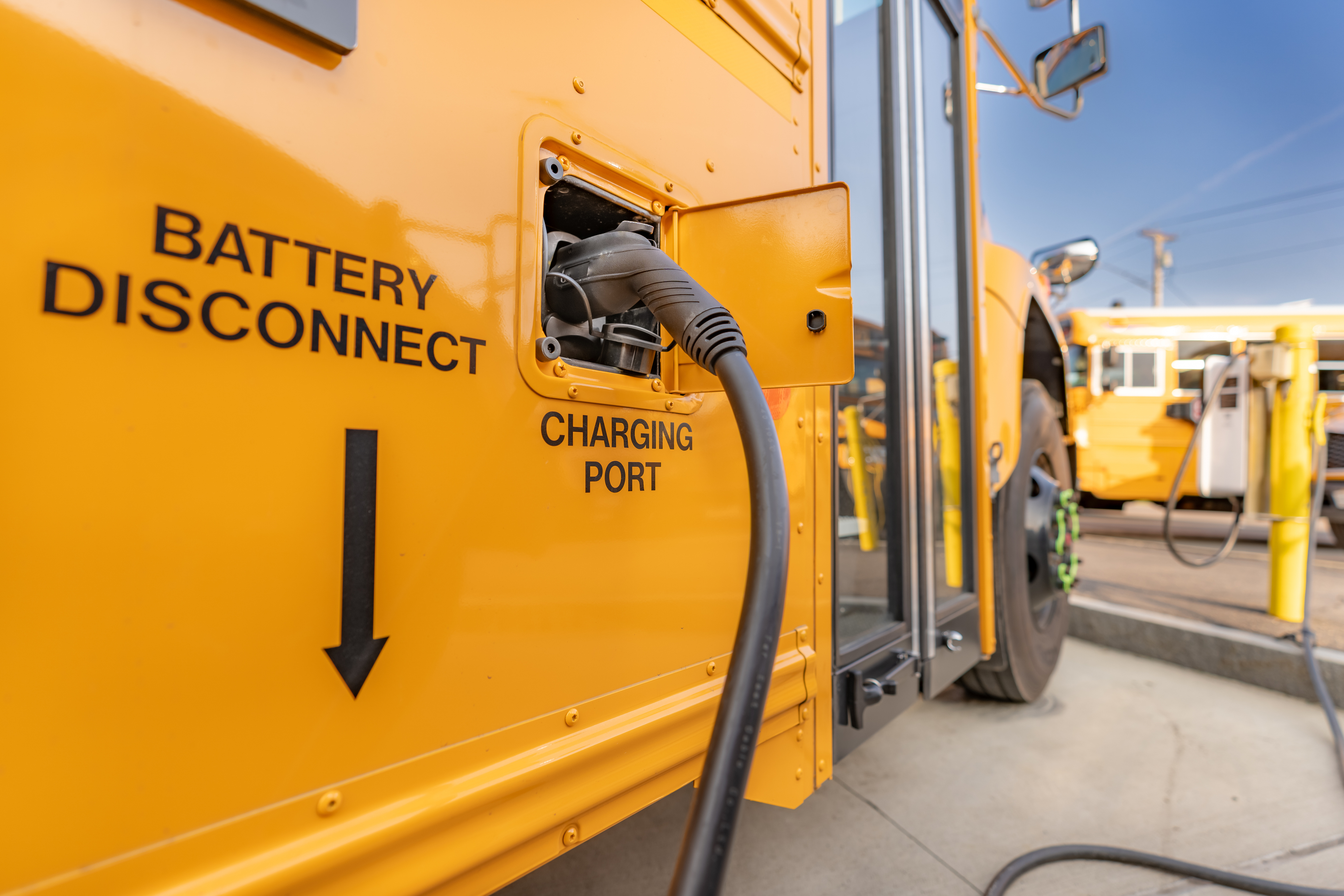 An electric school bus being charged.