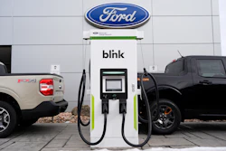 Ford electric vehicle charging station with Blink charger between two Ford trucks