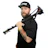 Bearded man in black hat holding camera tripod over shoulder Headshot