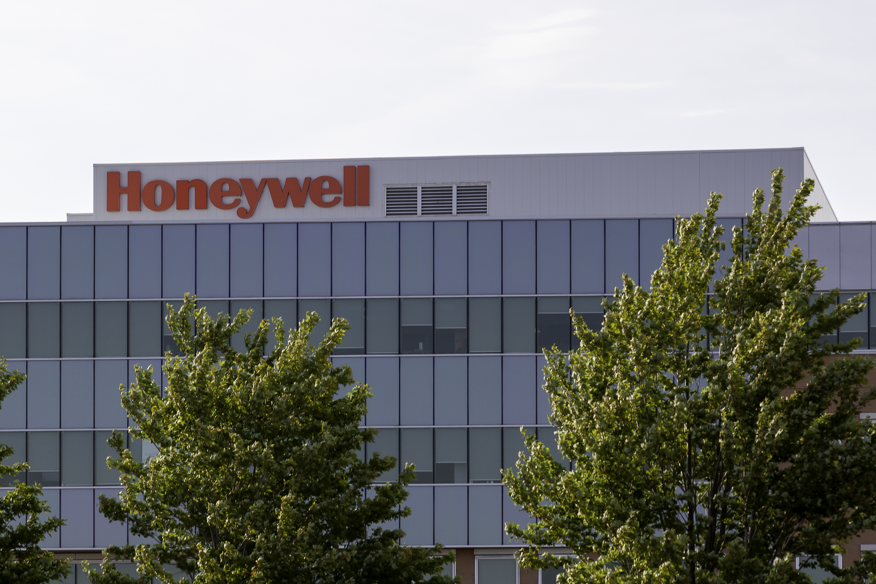 Honeywell corporate headquarters with glass exterior and green trees