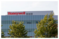 Honeywell corporate headquarters with glass exterior and green trees