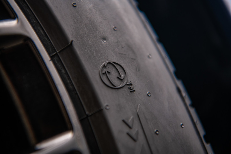 Close-up of tire sidewall with embossed manufacturer logo
