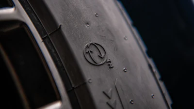 Close-up of tire sidewall with embossed manufacturer logo