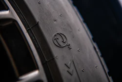 Close-up of tire sidewall with embossed manufacturer logo