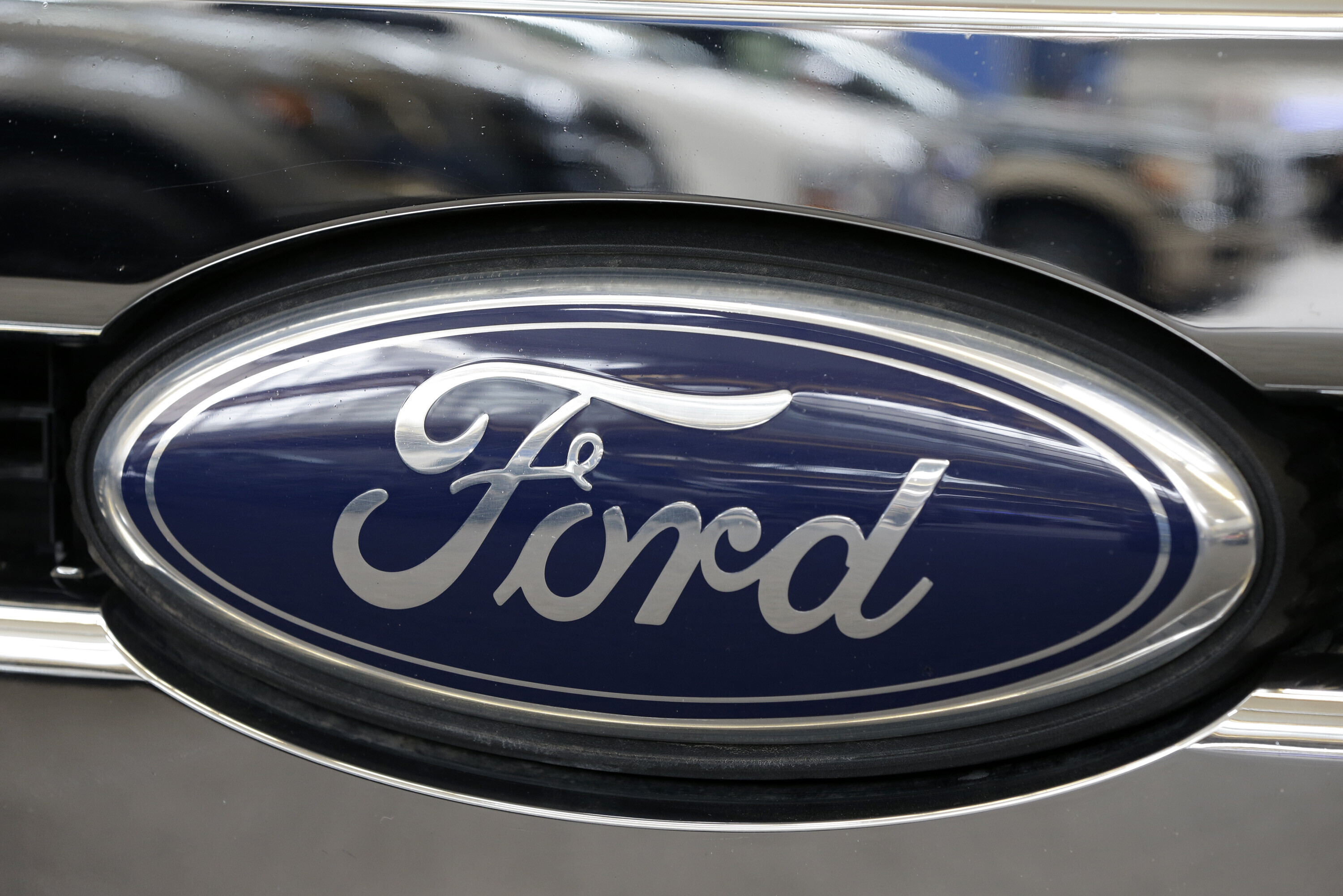 Ford automotive logo on vehicle grille with navy blue oval emblem
