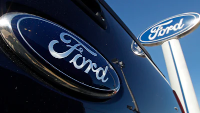 Ford automotive logo in dark blue on glossy vehicle surface