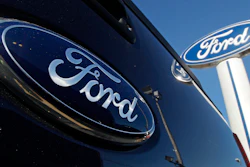Ford automotive logo in dark blue on glossy vehicle surface