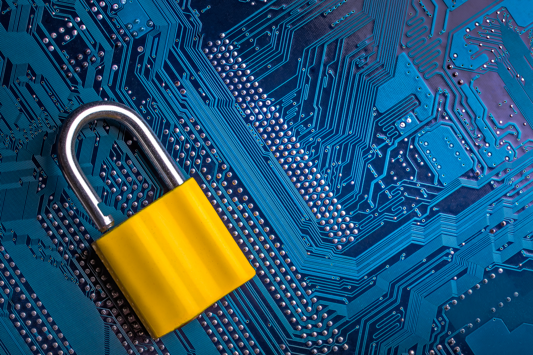 Yellow padlock on blue circuit board symbolizing digital security