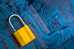 Yellow padlock on blue circuit board symbolizing digital security