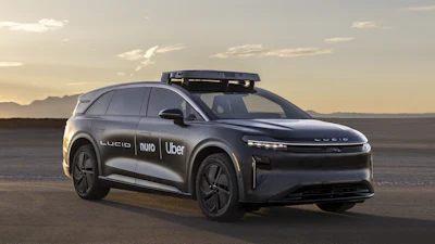 Black Lucid autonomous vehicle with Uber and Nuo branding at sunset