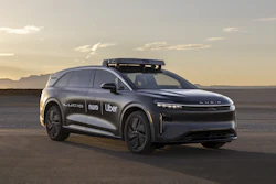 Black Lucid autonomous vehicle with Uber and Nuo branding at sunset