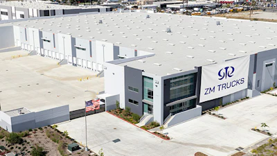 Aerial view of ZM Trucks manufacturing facility with white buildings and parking area