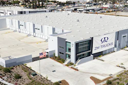 Aerial view of ZM Trucks manufacturing facility with white buildings and parking area