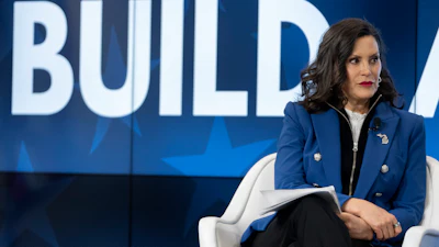 Woman in blue blazer speaking at BUILD conference event on stage